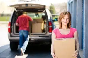 Grand junction woman and man happily moving into their new storage unit with All Secure Storage