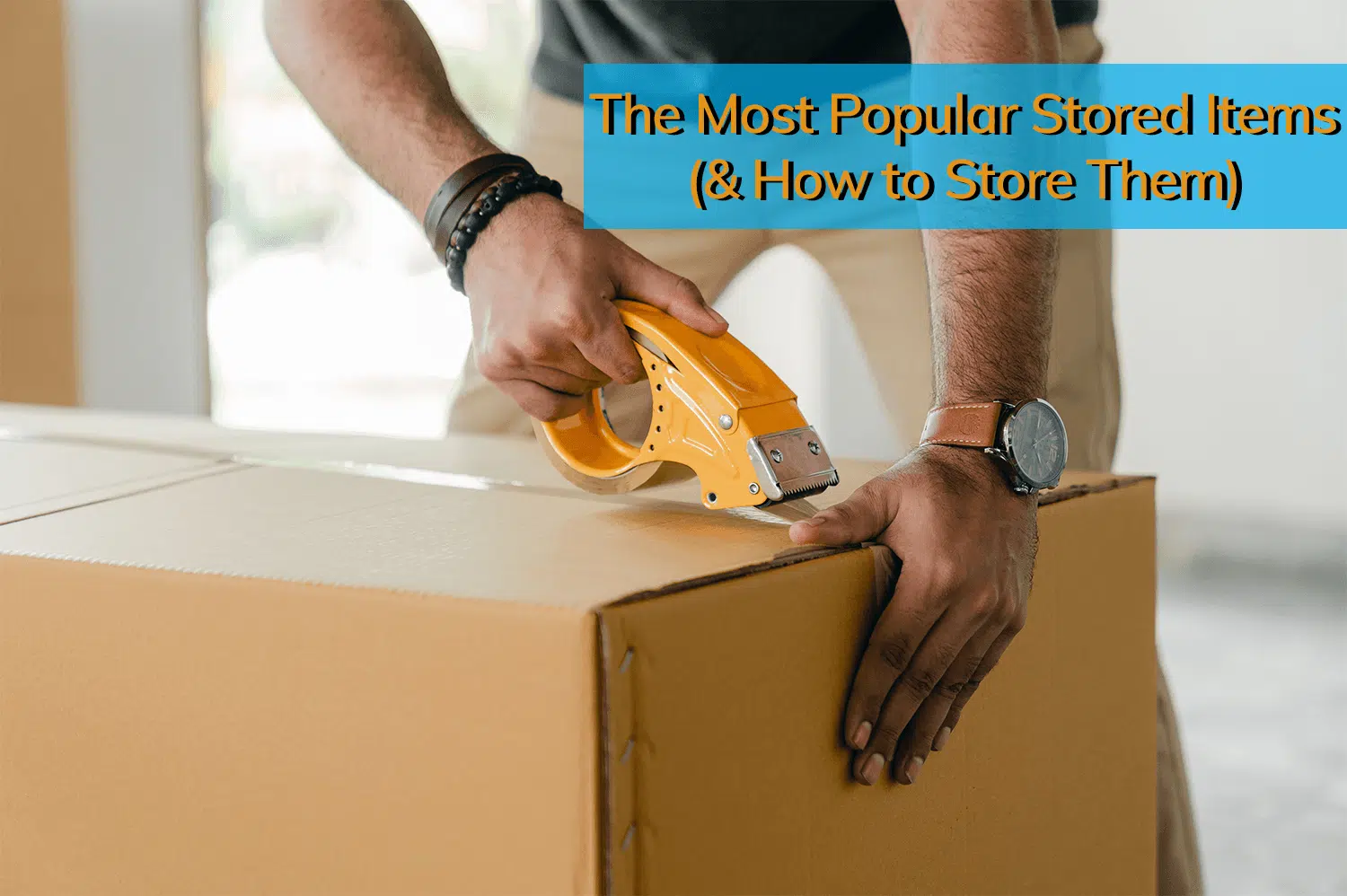 A man taping up a box with stored items inside.