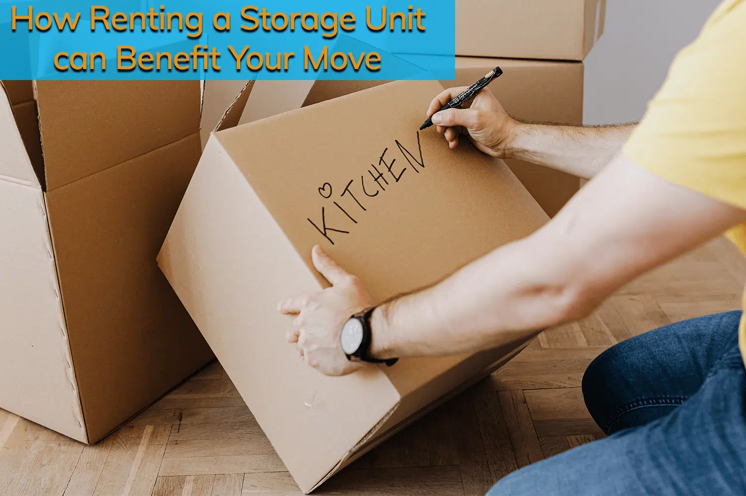 Anonymous person labeling a moving box "kitchen" before renting a storage unit.