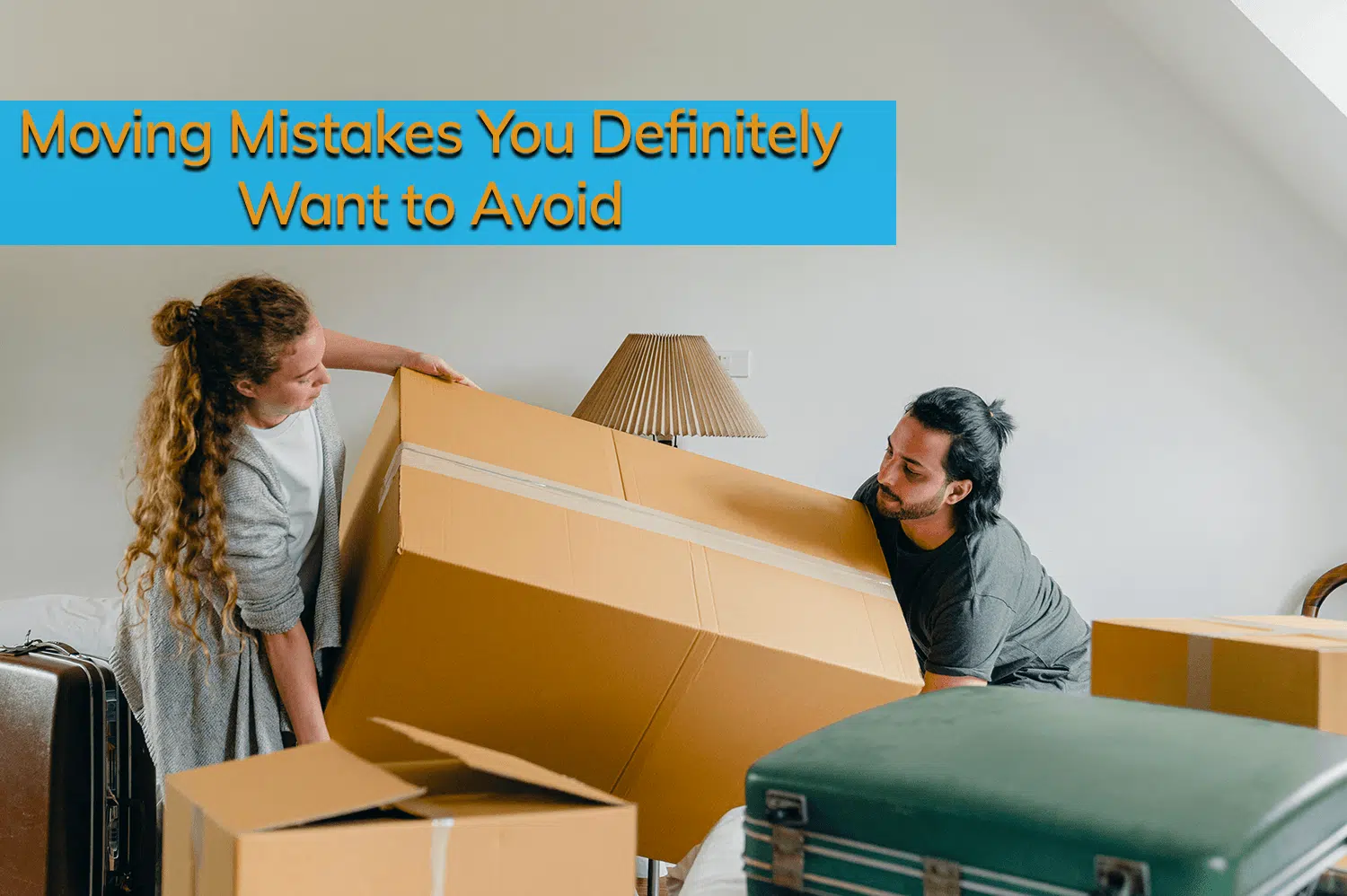 A man and a woman moving a big cardboard box into their home.