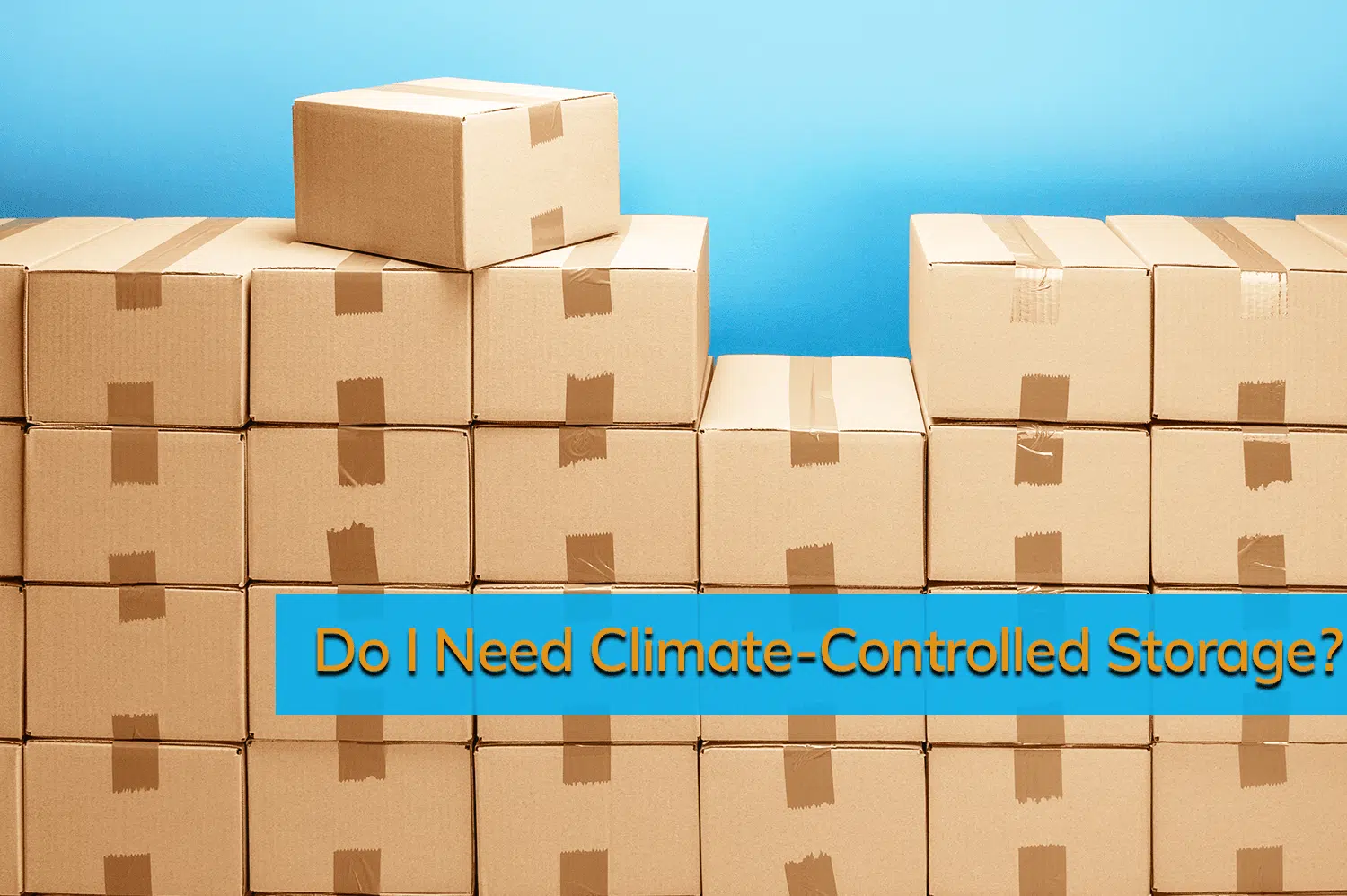 Stacked boxes in front of a blue wall waiting to go into a climate-controlled storage unit.