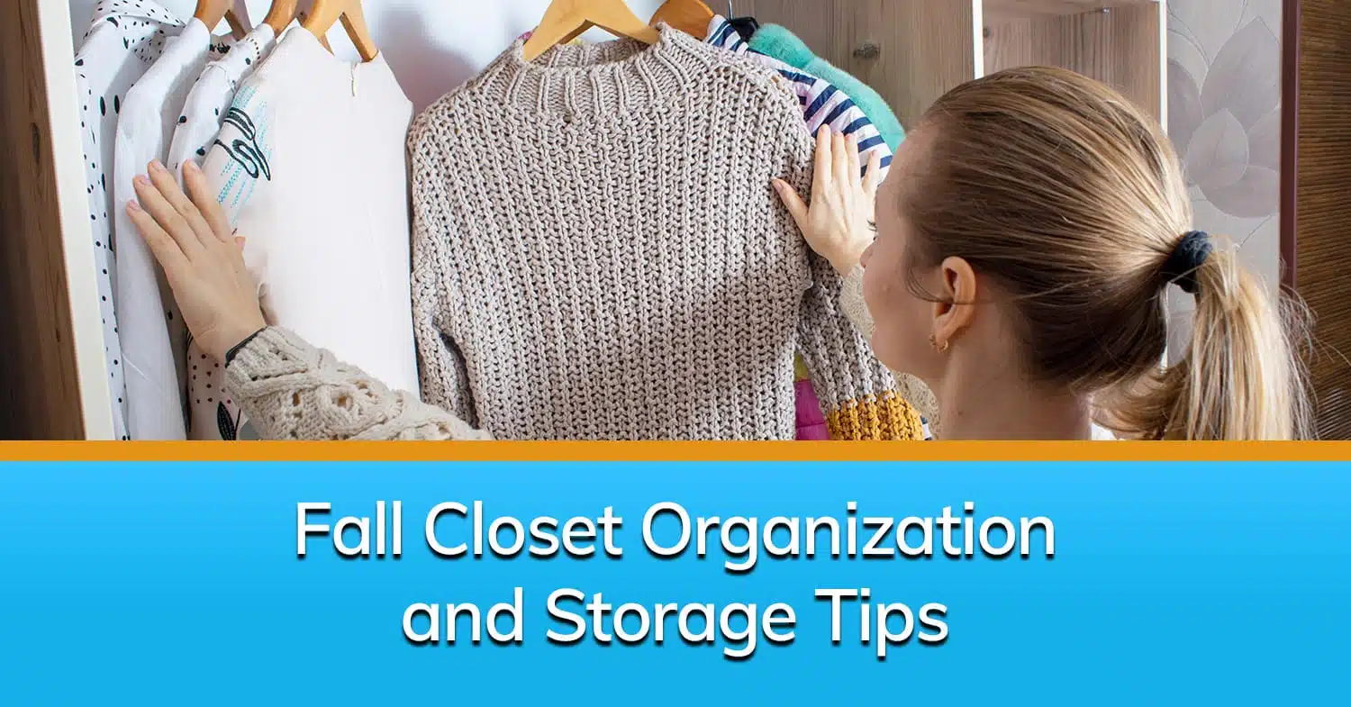 A woman looking at her sweaters hanging up after her closet organization.