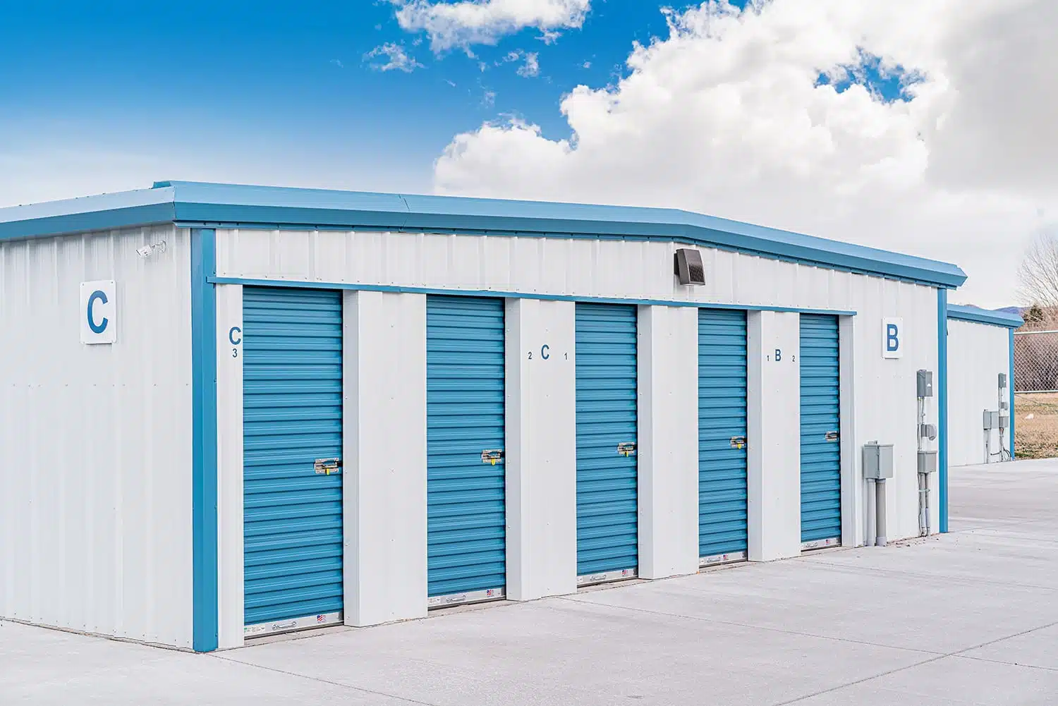 Building C with a row of 5x10 storage units and blue rollup doors