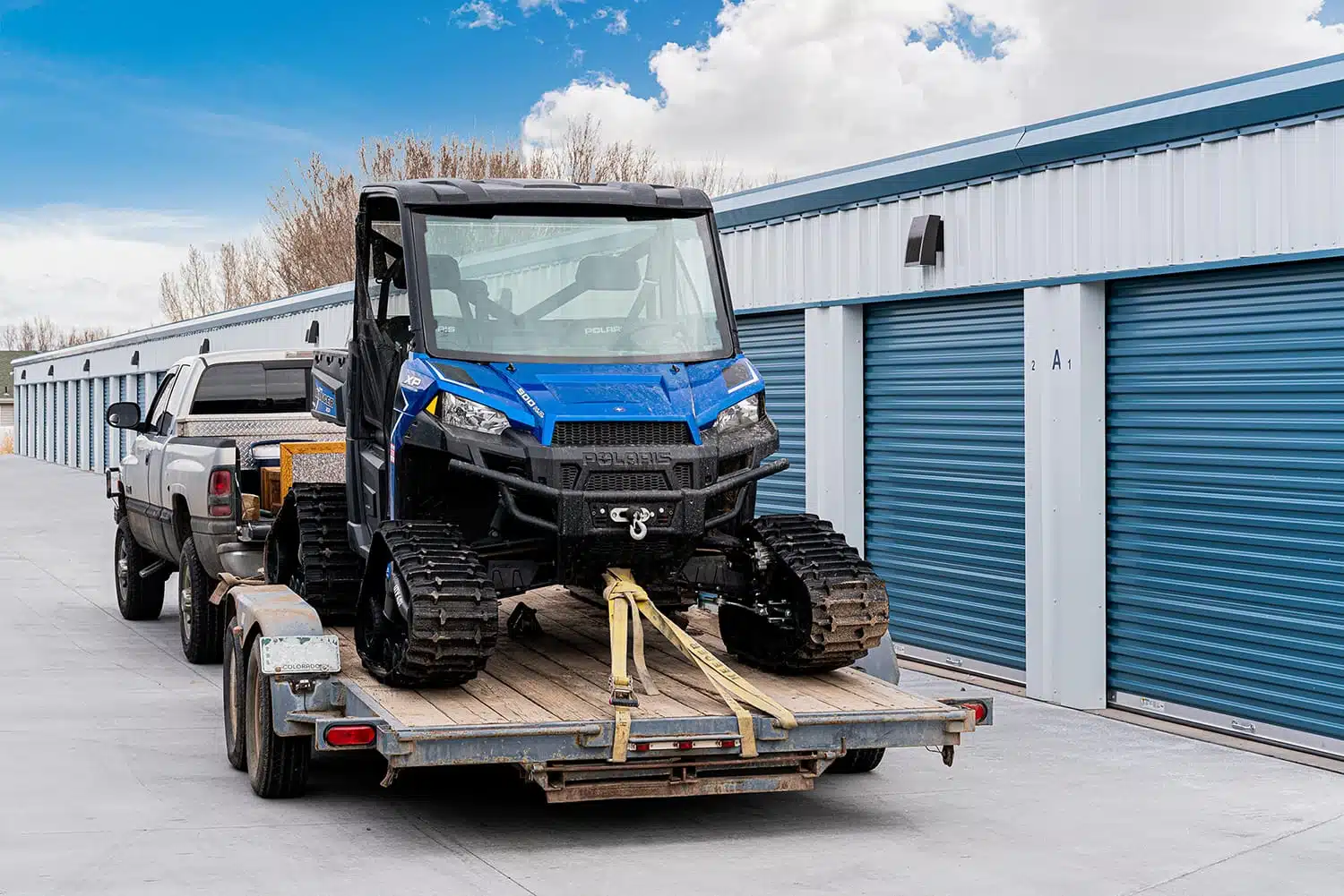 side-by-side on trailer next to storage unit