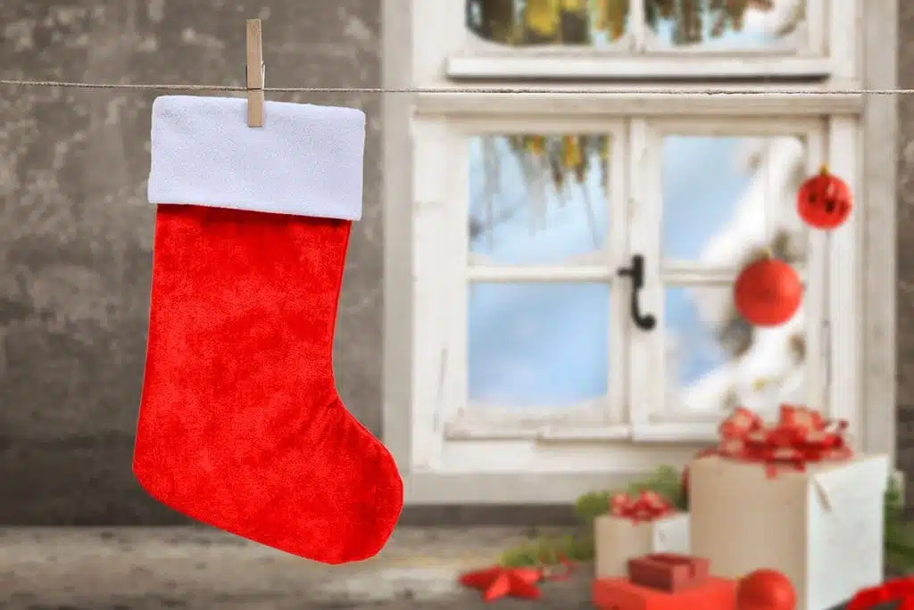 Empty Christmas Stocking hanging on rope to dry with Christmas theme background